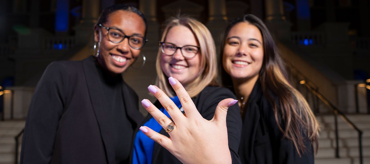 Group of alumni women show off their class ring