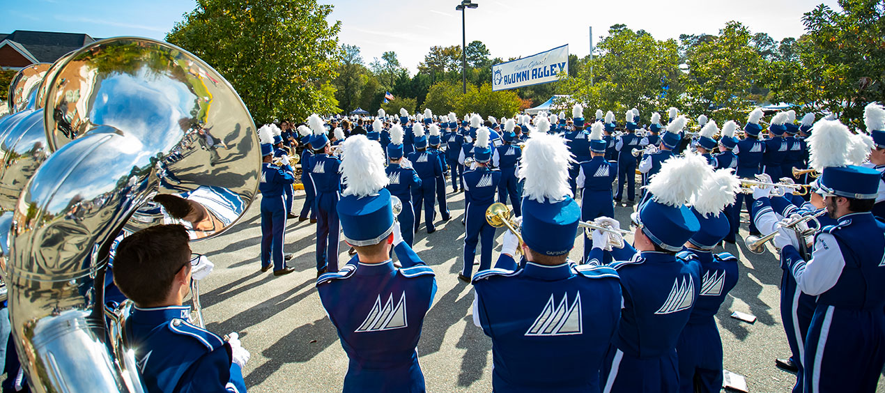 Marching band performing in Alumni Alley during CNU Homecoming